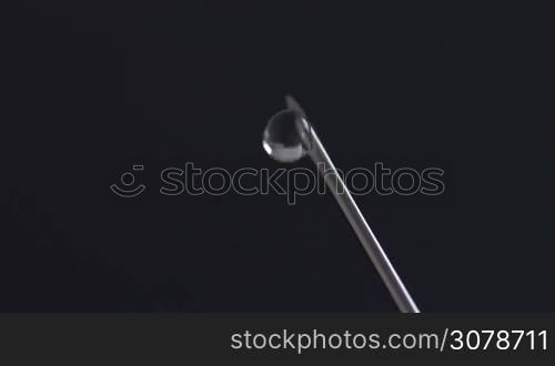 Extreme macro shot of Syringe needle dripping