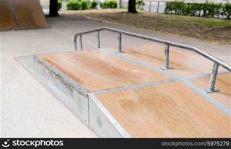 extreme sport, skateboarding, equipment and youth culture concept - close up of ramp at city skatepark