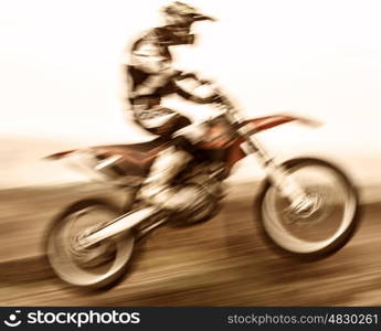 Extreme sport, slow motion on motorbike, pro race driver jumping on the dirt bike, motocross, speed and challenge concept