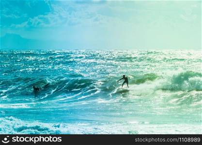 Extreme surfers riding some waves on the sea in France