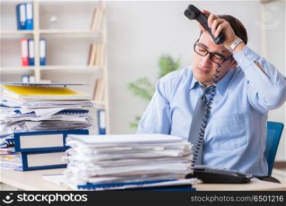 Extremely busy businessman working in office