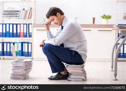 Extremely busy employee working in the office. The extremely busy employee working in the office