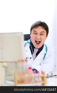 Extremely happy medical doctor working on computer&#xA;