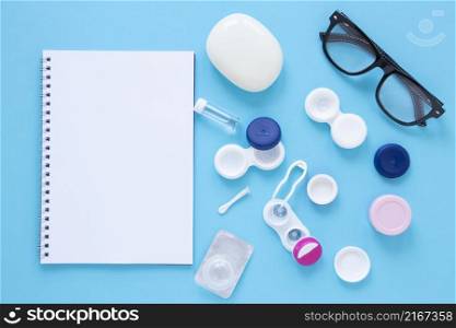 eye care products blue background with notebook mock up