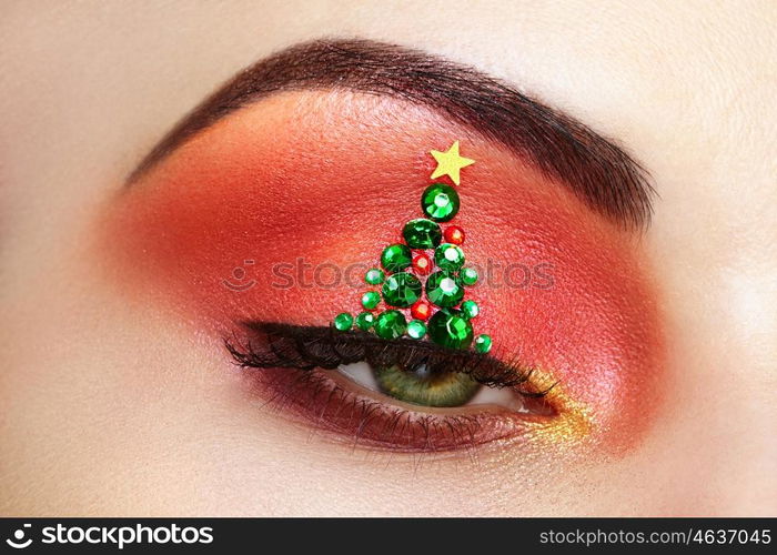 Eye girl makeover christmas tree. Winter christmas makeup. Beauty fashion. Eyelashes. Cosmetic Eyeshadow. Makeup detail. Creative woman holiday make-up