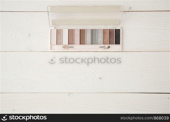 eye shadow on light wooden background. flat lay