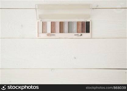 eye shadow on light wooden background. flat lay