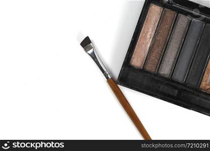 Eye shadows palette and brushes on white background.
