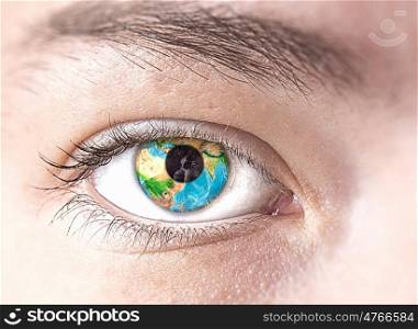 Eye with Earth planet. Close up of female eye with Earth planet. Elements of this image are furnished by NASA