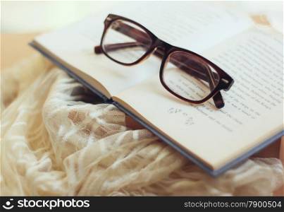 Eyeglasses and book with retro filter effect
