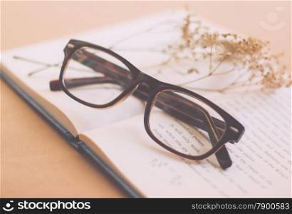 Eyeglasses and book with retro filter effect