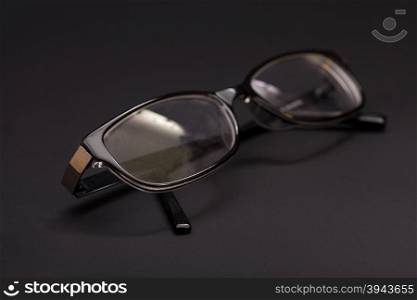 Eyeglasses in a black background