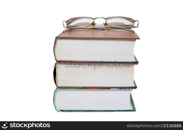 Eyeglasses on the books isolated on white