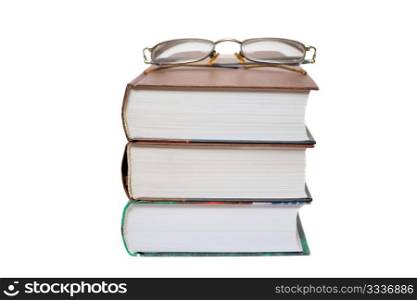 Eyeglasses on the books isolated on white