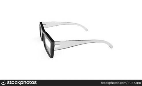 Eyeglasses rotates on white background