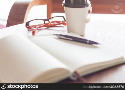 Eyeglasses with coffee cup in coffee shop, stock photo