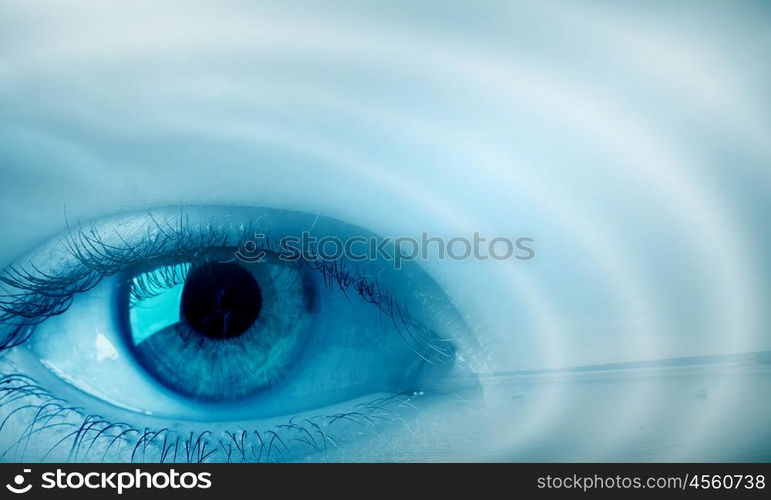 Eyes health. Female blue eye on cloudy sky background