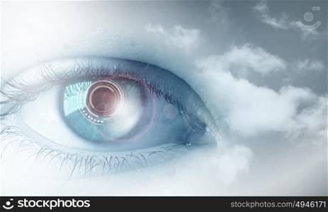 Eyes health. Female blue eye on cloudy sky background