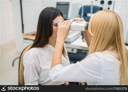 Eyesight test in optician cabinet, diagnostic of vision, professional choice of glasses. Patient and doctor, consultation with specialist, ophthalmology. Eyesight test in optician cabinet, ophthalmology