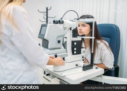 Eyesight test in optician cabinet, diagnostic of vision, professional choice of glasses lens. Patient and doctor, consultation with specialist, ophthalmology. Eyesight test in optician cabinet, choice of lens