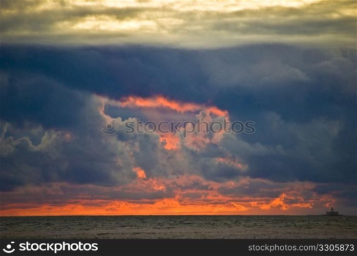 fabulous sunset with many clouds over the ocean
