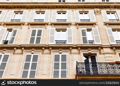 facacade of urban house with balcony in Paris, France