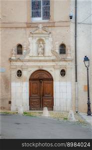 Facade and door of the Chapelle Saint-Louis, old chapel of the grey penitents, in the town of Brignoles in Provence, south of France