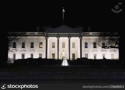 Facade of a government building lit up at night, White House, Washington DC, USA