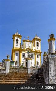 Facade of a historic church in Ouro Preto with blue sky in the background on sunny days. Facade of a historic church in Ouro Preto with blue sky