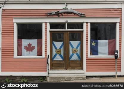 Facade of a house with flags in the window, Lunenburg, Nova Scotia, Canada