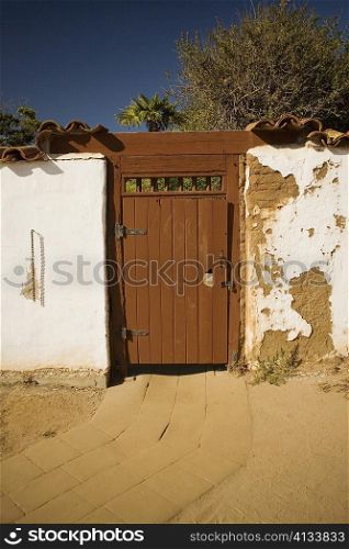 Facade of a wooden door on a stucco wall