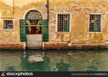 Facade of an old house on a canal in Venice, Italy