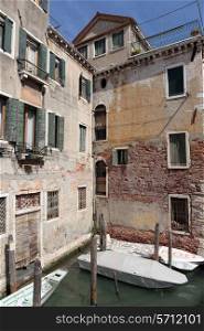 Facade of an old house on a canal in Venice, Italy