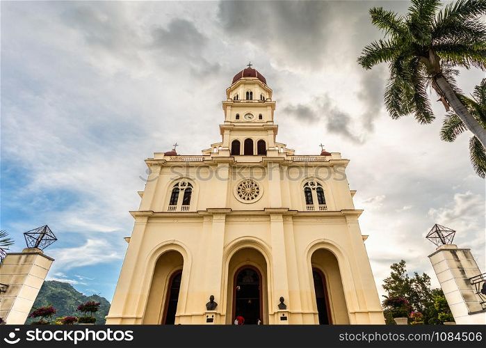 Facade of basilica in honour of Our Lady of Charity with palm, El Cobre, Santiago de Cuba, Cuba