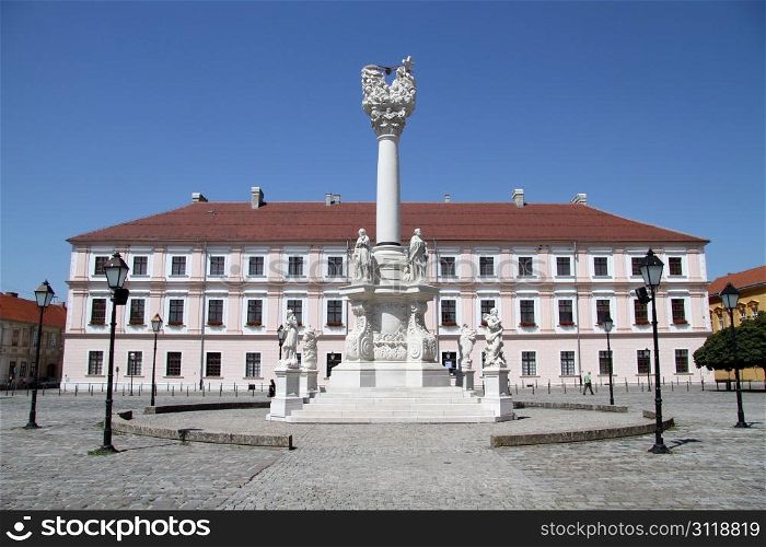 Facade of big building and white column on the square in Osijek, Croatia
