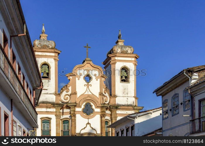 Facade of historic colonial style house and church in the famous city of Ouro Preto in Minas Gerais, Brazil. Facade of historic colonial style house and church in Ouro Preto city