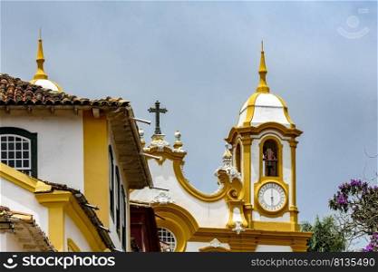 Facade of historic colonial style house and church in the famous city of Tiradentes in Minas Gerais, Brazil. Facade of historic colonial style house and church in Tiradentes city