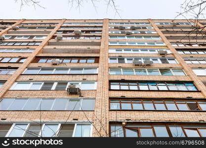 facade of multistory brick urban house in winter day