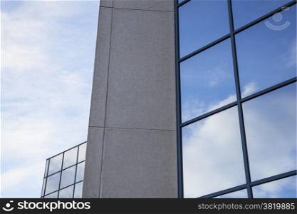 facade of office building with very blue sky and clouds