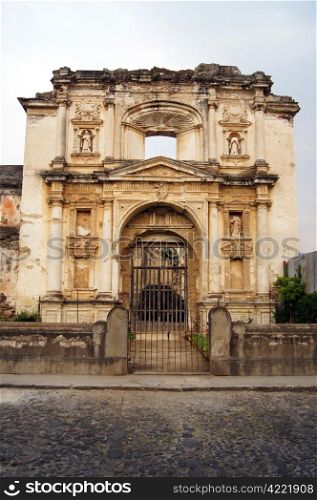 Facade of old church on the coblestone street in Antigua