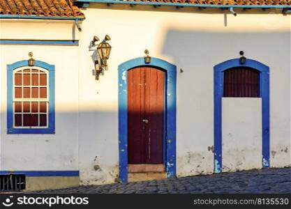 Facade of old house in colonial architecture in the city of Ouro Preto, Minas Gerais with blue windows and door. Facade of old house in colonial architecture with blue windows and door