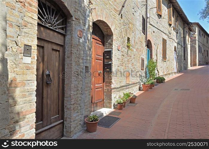 facade of stone houses in a paved street in Italy - tuscany - marcialla village. facade of stone houses in a paved street in Italy - tuscany- marcialla village
