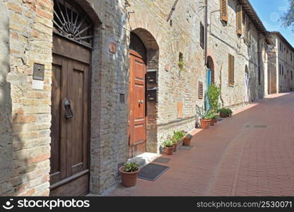 facade of stone houses in a paved street in Italy - tuscany - marcialla village. facade of stone houses in a paved street in Italy - tuscany- marcialla village