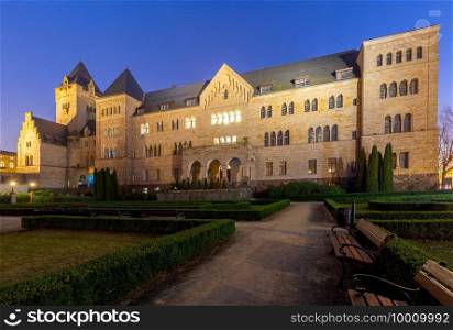 Facade of the imperial castle and garden at sunset. Poznan. Poland.. Poznan. Imperial castle at sunset.