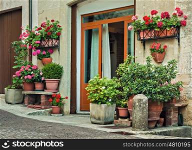 Facade of the old Italian house with flowers