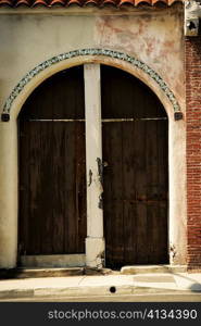 Facade of wooden doors on a stucco building, Los Angeles, California, USA