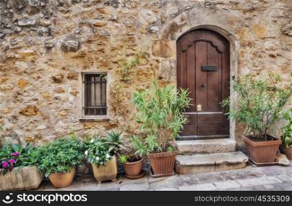 Facade with flowers of the old house in medieval village France