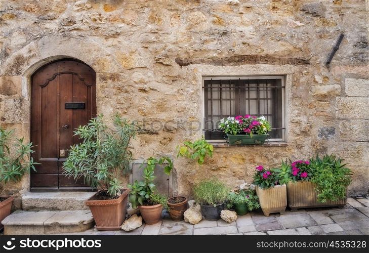 Facade with flowers of the old house in medieval village France