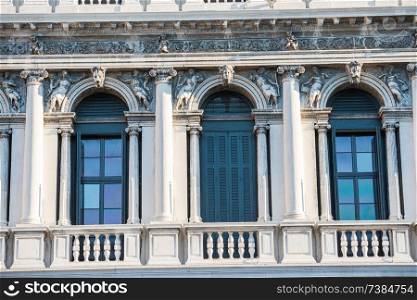 Facade with windows, columns and decorations of old building at Piazza San Marco. Venice, Italy 