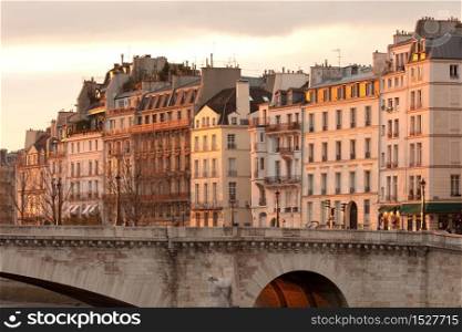 Facades of apartment buildings at Ile Saint Louis and Pont de la Tournelle bridge, Paris, France